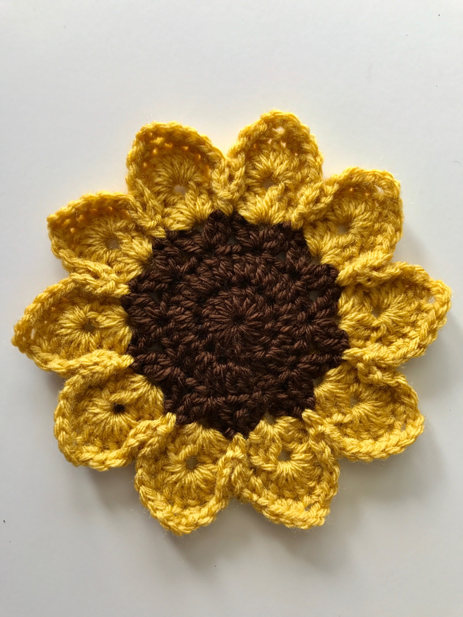 Stunning Jumbo Sunflower Applique -- this crocheted Sunflower looks stunning on a hat! The pattern can also be used to make a fun scrubby! Free pattern